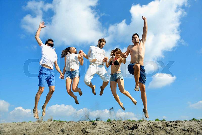 Image of young people jumping together outdoor, stock photo