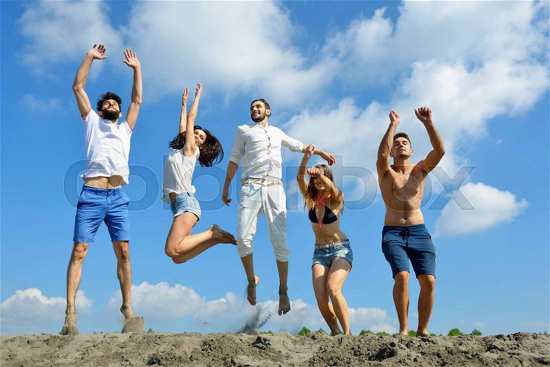 Image of young people jumping together outdoor, stock photo