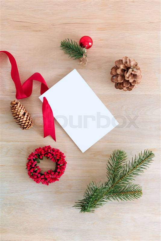 Packing Christmas gifts. Blank gift card with free space for text and holiday decorations. Top view, stock photo