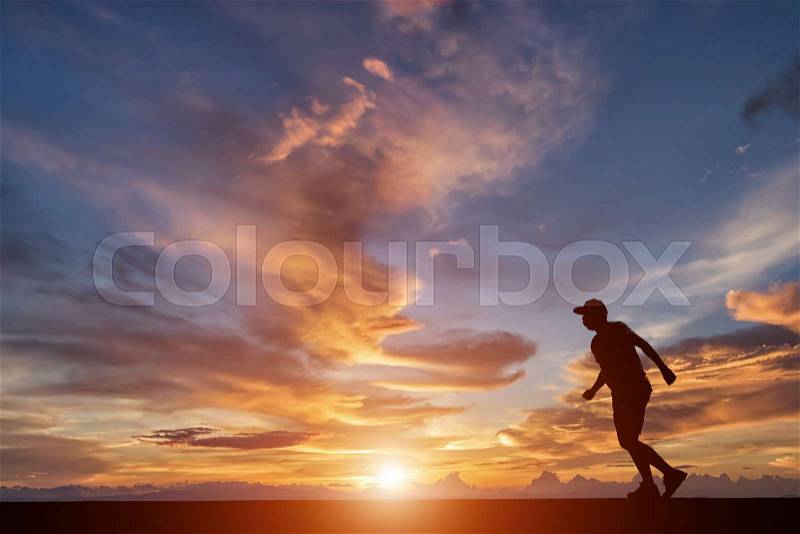 Silhouette of happy people running on street in sunset, stock photo