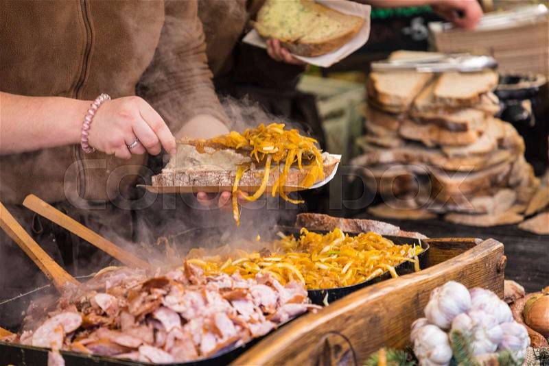 Food booth selling traditional Polish street food in Main Square, Kraków at Christmas market, stock photo