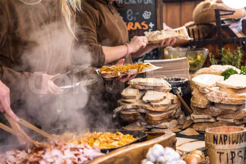 Food booth selling traditional Polish street food in Main Square, Kraków at Christmas market, stock photo