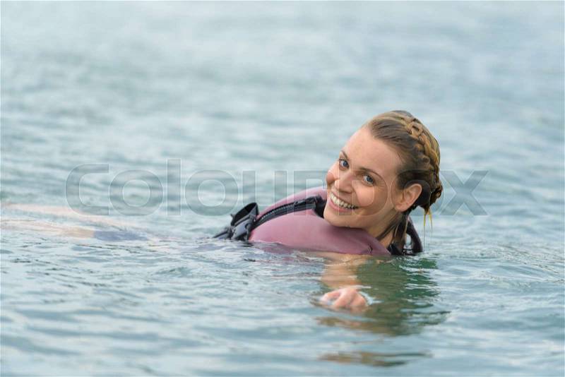 Beautiful young girl floats in the water, stock photo
