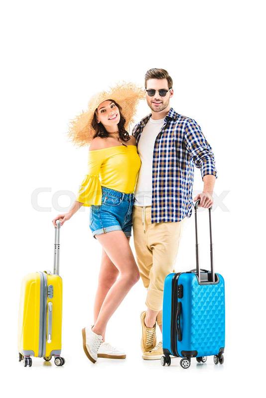 Happy couple of tourists holding luggages and hugging each other isolated on white, stock photo