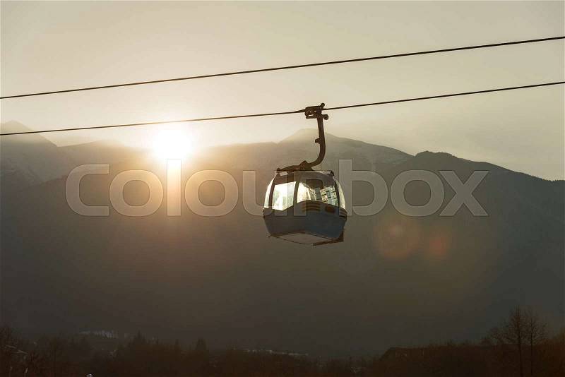 Ropeway and cable car transport system for skiers in sunset, stock photo