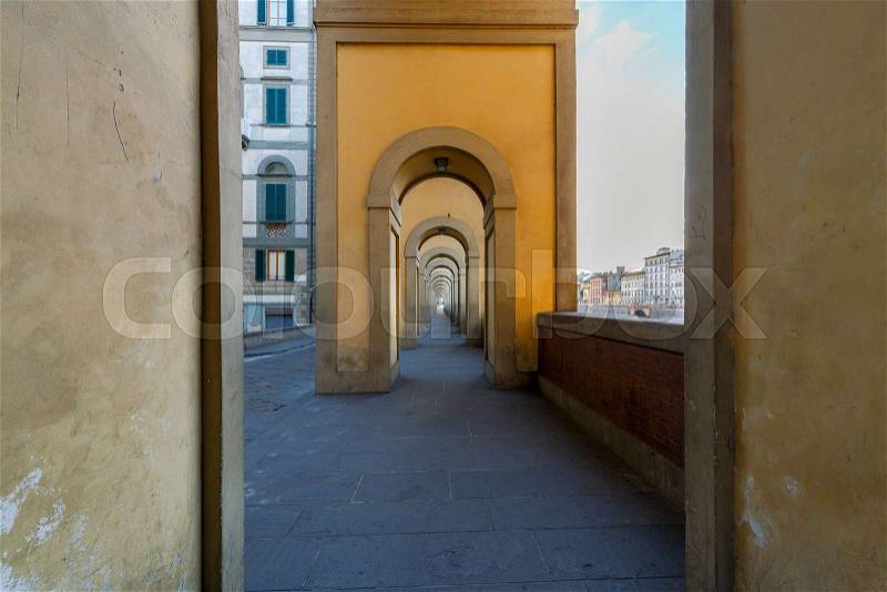 Old medieval gallery on the city embankment along the Arno River. Italy. Florence, stock photo