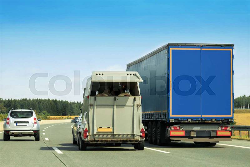 Truck and horse trailer on the road in Switzerland, stock photo