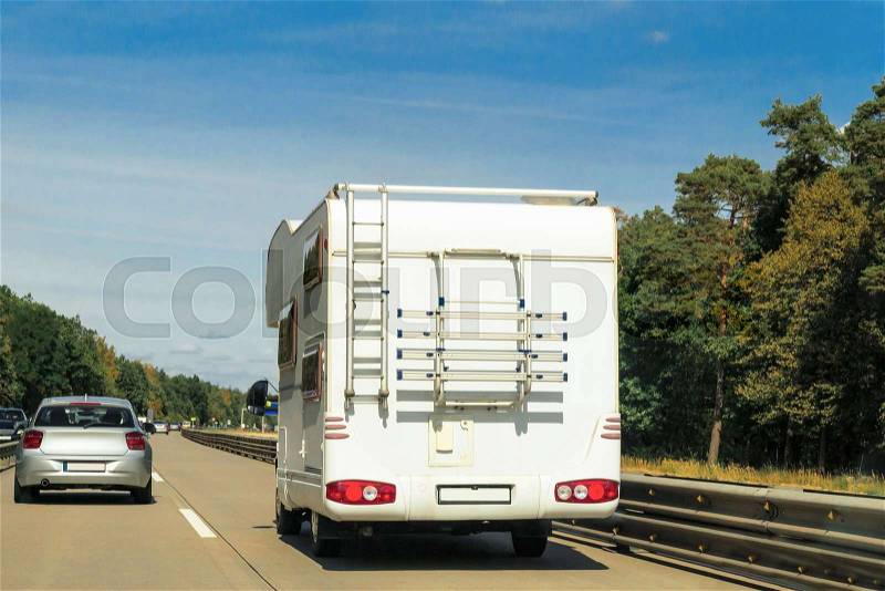 Caravan and car on the road in Switzerland, stock photo