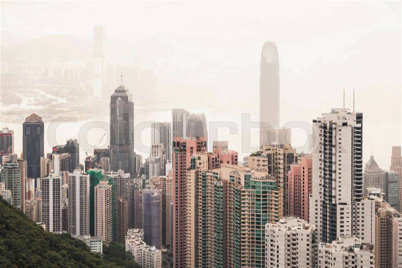 Cityscape of Hong Kong city in foggy day, aerial view taken from Victoria Peak viewpoint, stock photo
