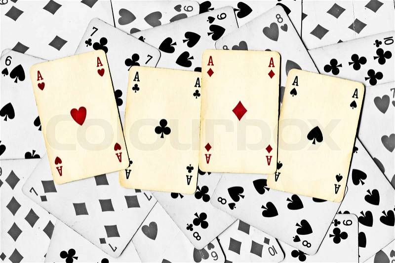 Four color aces on a black and white cards background, stock photo