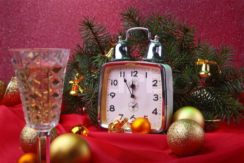Christmas clock and glass champagne wine. New Year\'s Decoration with gift boxes, christmas balls and tree. Celebration Concept for New Year, stock photo