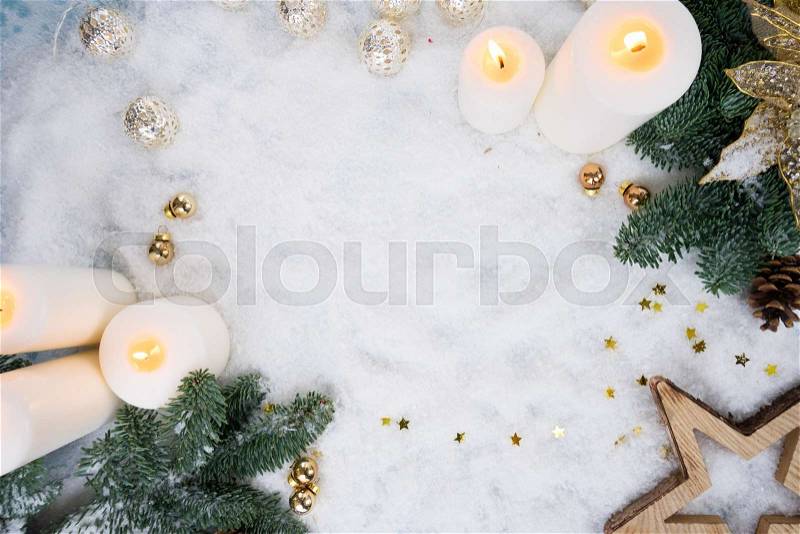 Christmas glowing advent candles scene with fir tree and snow, stock photo