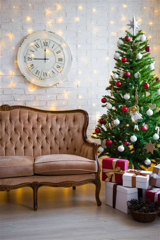Christmas background - room with decorated christmas tree, vintage sofa, lights and gift boxes, stock photo