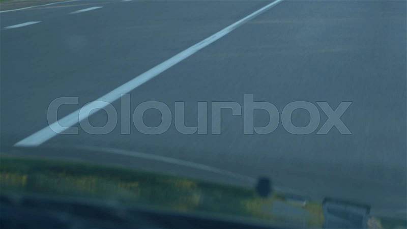 White lines of road marking. A shot from a moving car, stock photo