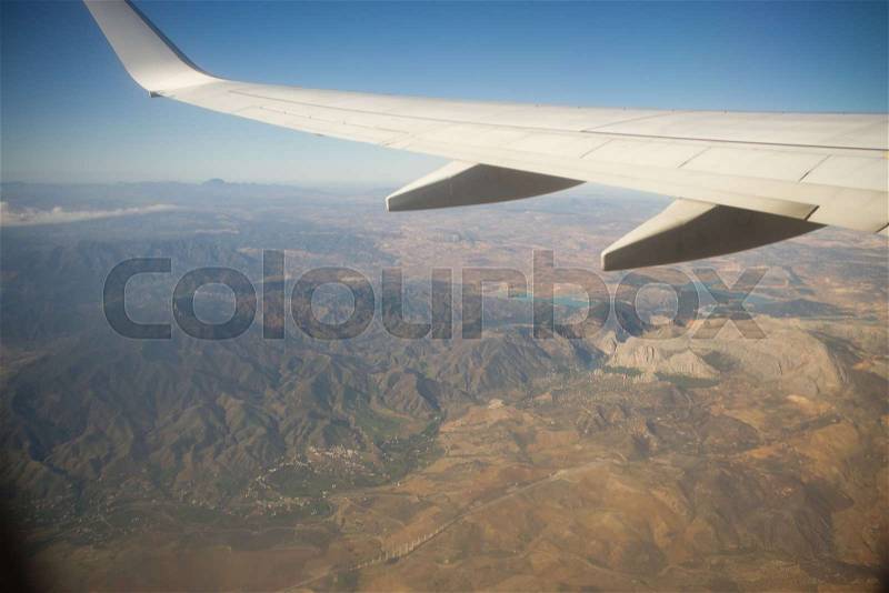 View from the airplane window. Beautiful scenery from an unexpected perspective. Terraneous objects seem to be toy, stock photo