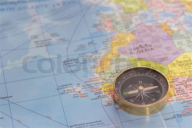Close up magnetic compass on a world map conceptual of global travel , tourism and exploration. Business and travel concept, stock photo