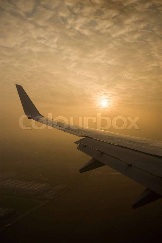 The sun is through the clouds. View from the airplane window, stock photo