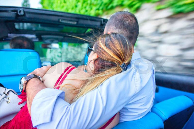 Romantic couple embracing in the taxi car at Capri Island, Italy, stock photo