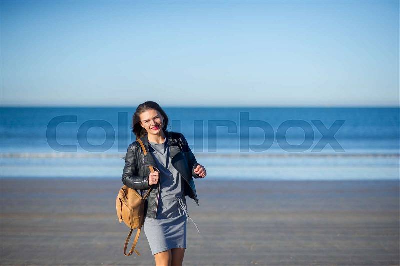 Portrait of the nice young woman against the background of a sea landscape, stock photo