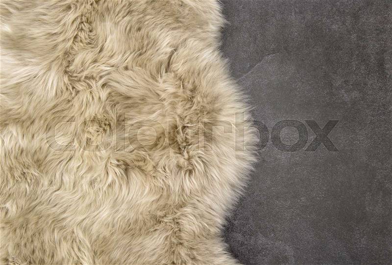 Sheep fur. Sheepskin rug background. Wool stone texture, stock photo