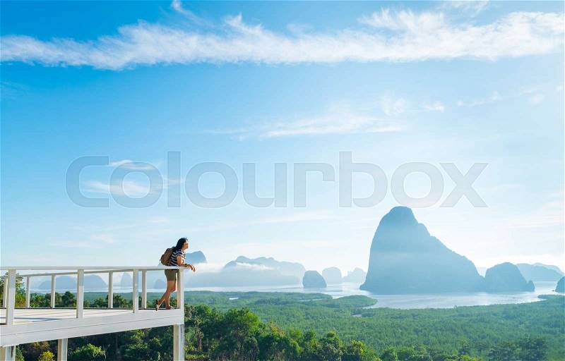 Happy young traveler woman backpacker chill out and enjoying a beautiful sky of nature at mountain panorama view point and sea,Freedom wanderlust,Khao Samed Nang Chee Viewpoint,Phang Nga,Thailand, stock photo