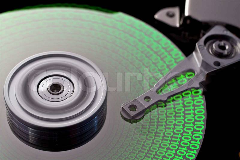 Studio photography of a opened hard disk with symbolic data, stock photo