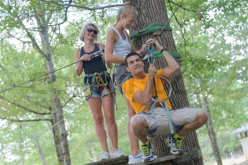Friends having fun during tree top adventures, stock photo