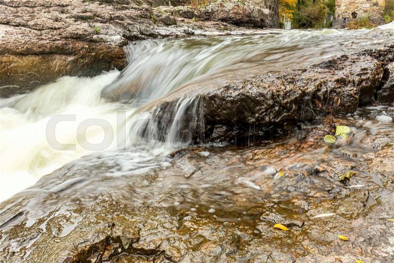 Powerful mountain river close up. Crystal water flows through mossy boulders and rocks. Dark vintage toning filter. Buky Canyon on the Hirs\'kyi Tikych river in Ukraine, stock photo