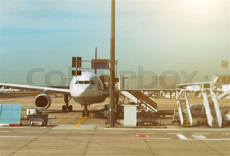 Passenger plane in the airport at sunrise. Aircraft maintenance, stock photo