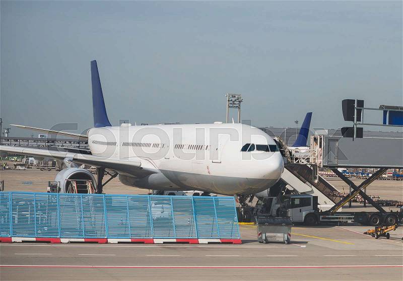 Passenger plane in the airport. Aircraft maintenance, stock photo