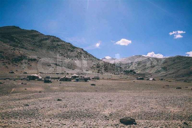 Mountain camp with cars and tents in Indian Himalayas, Ladakh region, stock photo