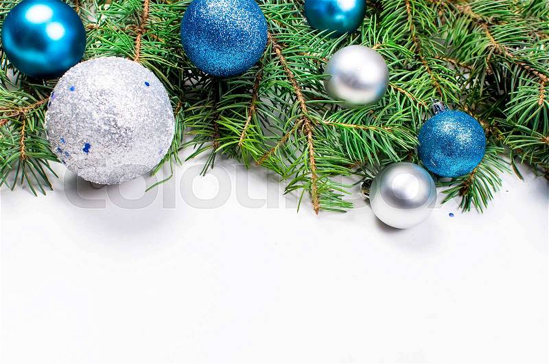 Decorative background with fir branches ,blue and silver balls on the white . Christmas card Holiday Concept. copy space, top view, stock photo