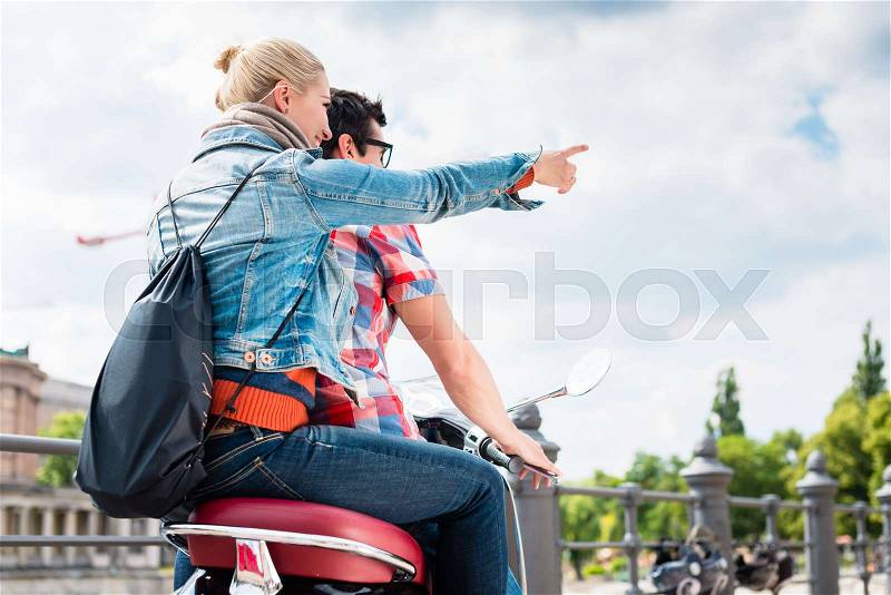 Young couple, woman and man, doing a scooter trip to the Berlin Museum Island, stock photo
