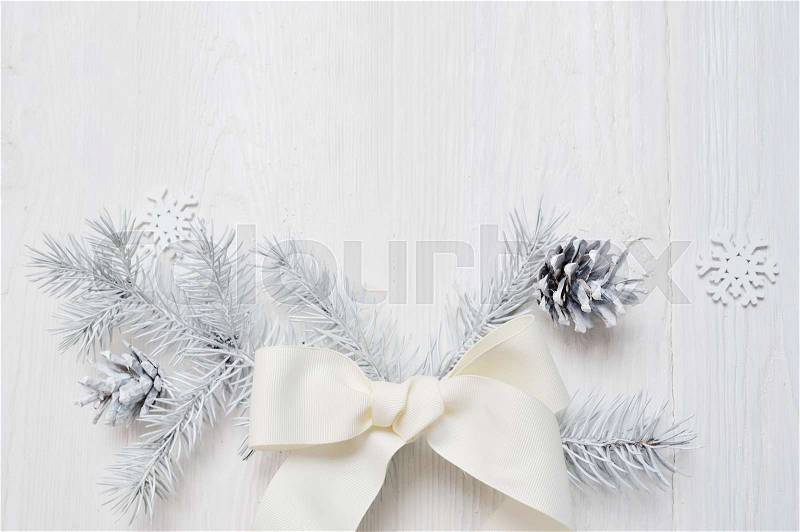 Mockup Christmas white tree and cone, ribbon bow. Flatlay on a white wooden background, with place for your text, stock photo