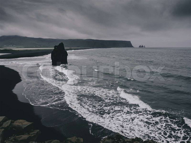 Black sand beach with rocks, Vik, Iceland, stock photo
