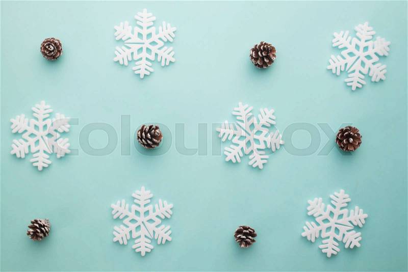 Merry Christmas and Happy New Year. Pattern foam cutter snowflake and dried pine on pastel color, stock photo