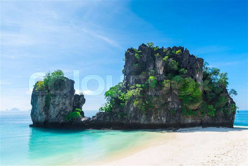 Two cliffs in the Andaman Sea near the beach of the island of Hong, Thailand, stock photo