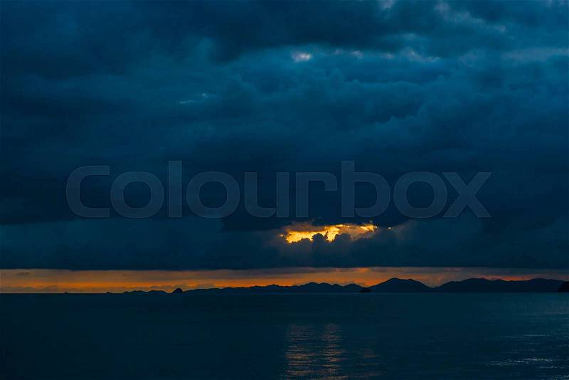 Black heavy blue clouds over the sea after sunset, Thailand resort, stock photo