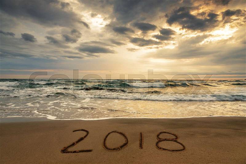 2018 written on the sand of a beach, travel 2018 new year concept, stock photo