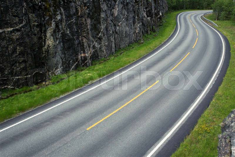 Empty winding forest road at the mountains , stock photo