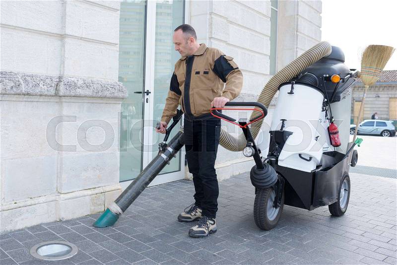 Street sweeper collects leaves from the fan motor, stock photo