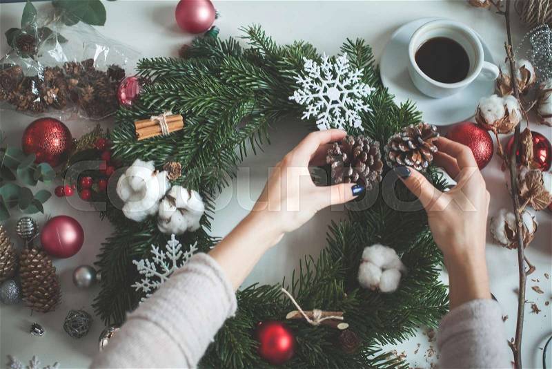 Winter Holidays Concept. Christmas Decorations, Glass Balls, Evergreen Tree Twig, Female Hands, stock photo