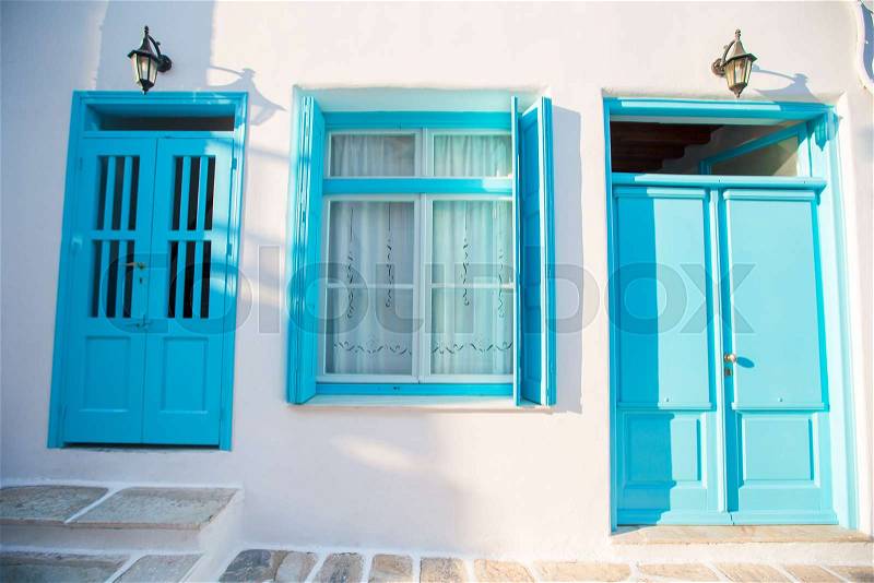 Traditional houses withe blue doors in the narrow streets of Mykonos, Greece, stock photo