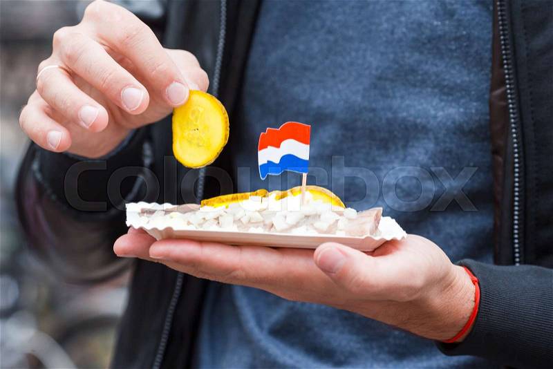 Traditional dutch food: herring fish with onion in fastfood market of Amsterdam, Netherlands, stock photo