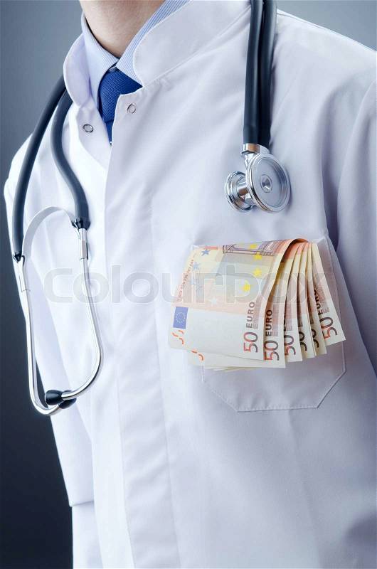 Doctor with money in studio, stock photo