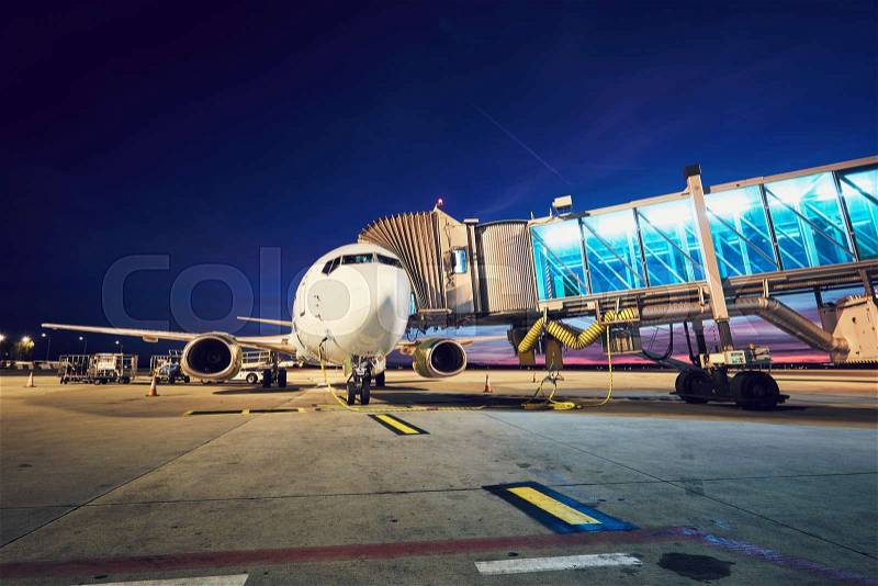 Busy airport after sunset. Preparation of the airplane before flight. Prague Czech Republic, stock photo