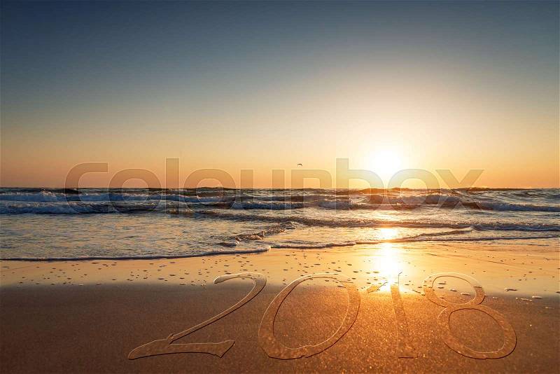 2018 written on the sand of a beach, travel 2018 new year concept, stock photo