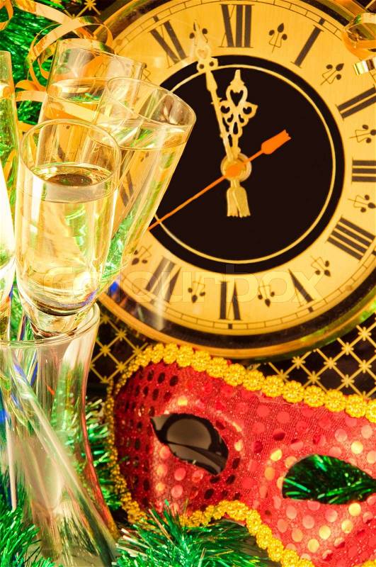 Christmas card Glasses of champagne on New Year\'s Eve against an ancient wall clock, stock photo