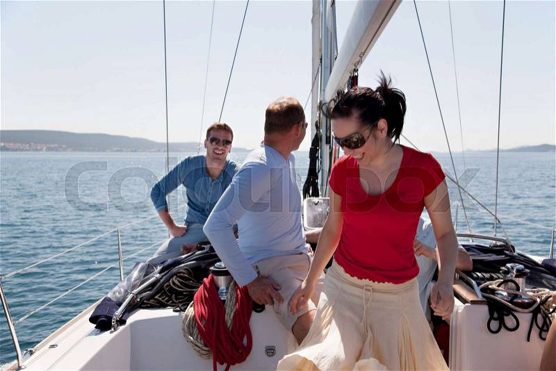 Men and woman on yacht, stock photo