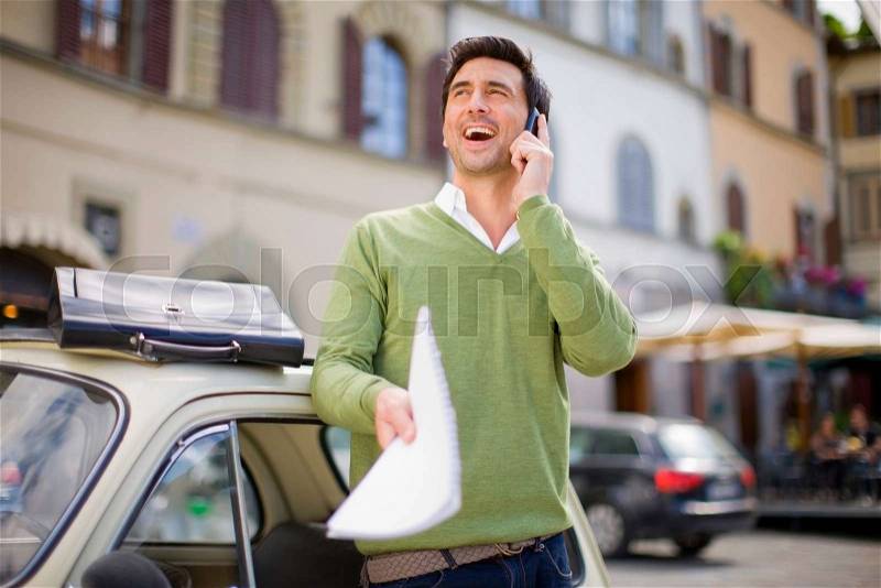 Man with car and briefcase laughing, stock photo